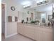 Bathroom with double sink vanity with ample counter space and a large mirror reflecting the shower at 3824 Dominic St, North Port, FL 34288