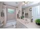 Well-lit bathroom featuring a tub with shower, toilet, vanity, and ample storage space at 3824 Dominic St, North Port, FL 34288