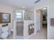 Modern bathroom with a glass-enclosed shower and neutral tile at 3824 Dominic St, North Port, FL 34288