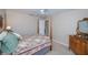Bedroom featuring a four-poster bed with a decorative quilt, a window with blinds, and furniture at 3824 Dominic St, North Port, FL 34288