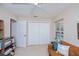 Neutral bedroom with a ceiling fan, closet, and a view of the pool area at 3824 Dominic St, North Port, FL 34288