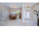 Inviting dining area with round table and harp, adjacent to the front door at 3824 Dominic St, North Port, FL 34288
