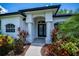 Inviting entrance showcasing manicured landscaping, elegant front door, and decorative architectural details at 3824 Dominic St, North Port, FL 34288