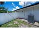 Exterior utility area with air conditioner and access door at 3824 Dominic St, North Port, FL 34288