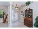 Welcoming foyer featuring high ceilings, elegant light fixture, and classic decor at 3824 Dominic St, North Port, FL 34288