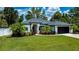 Well-maintained home with manicured lawn, beautiful plants, and a two-car garage at 3824 Dominic St, North Port, FL 34288