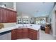 Open-concept kitchen with stainless steel appliances, white quartz countertops, and view to living area at 3824 Dominic St, North Port, FL 34288