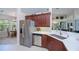 Modern kitchen with stainless steel appliances, white quartz countertops, and wooden cabinets at 3824 Dominic St, North Port, FL 34288