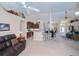 Open floor plan with kitchen, living, and dining areas, featuring tile flooring and natural light at 3824 Dominic St, North Port, FL 34288