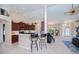 Open-concept living space boasts a breakfast bar, kitchen, dining area, and front door at 3824 Dominic St, North Port, FL 34288