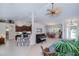Open-concept living space boasts a piano, breakfast bar, and dining area with lots of natural light at 3824 Dominic St, North Port, FL 34288