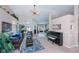 Bright living room features carpeted floors, a ceiling fan, comfortable seating, and lovely views of the pool area at 3824 Dominic St, North Port, FL 34288