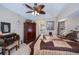 Main bedroom featuring tray ceiling, a comfortable bed and dark wood furniture at 3824 Dominic St, North Port, FL 34288