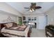 Comfortable main bedroom boasts a ceiling fan and access to the pool area at 3824 Dominic St, North Port, FL 34288