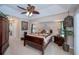 Comfortable main bedroom boasts a ceiling fan, nightstands, and tasteful decor at 3824 Dominic St, North Port, FL 34288