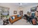 Well-lit office featuring a brown leather sofa, ceiling fan, and built in shelving around a desk at 3824 Dominic St, North Port, FL 34288