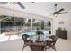 Inviting screened-in patio with dining and lounge areas overlooking a pool and spa at 3824 Dominic St, North Port, FL 34288