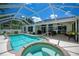 Relaxing screened-in pool and spa with a spacious patio for outdoor entertaining at 3824 Dominic St, North Port, FL 34288