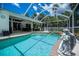 Screened pool with attached spa and spacious deck perfect for relaxing and entertaining outdoors at 3824 Dominic St, North Port, FL 34288