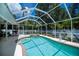 Outdoor pool and spa surrounded by a screened-in enclosure at 3824 Dominic St, North Port, FL 34288