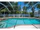 Enjoy this screened-in pool and hot tub area with lush landscaping and a beautiful patio at 3824 Dominic St, North Port, FL 34288