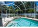 Inviting screened pool with spa and lush landscaping, creating a private outdoor oasis at 3824 Dominic St, North Port, FL 34288