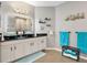 Modern bathroom with dual vessel sinks, granite countertops, and decorative fish art at 4180 Lenox Blvd, Venice, FL 34293