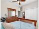 Bedroom showcasing a wooden bed frame, dresser, and closet at 4180 Lenox Blvd, Venice, FL 34293