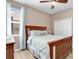 Comfortable bedroom featuring a wooden bed frame, ceiling fan, and window at 4180 Lenox Blvd, Venice, FL 34293