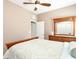 Cozy bedroom with a ceiling fan, dresser, and a decorative 'Beach Please' sign at 4180 Lenox Blvd, Venice, FL 34293