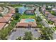 Aerial view of a community center with a swimming pool surrounded by lounge chairs at 4180 Lenox Blvd, Venice, FL 34293