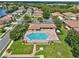Aerial view of a resort-style community pool with plenty of seating and lush landscaping at 4180 Lenox Blvd, Venice, FL 34293