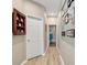 Neutral hallway featuring hardwood floors and decorative wall hangings at 4180 Lenox Blvd, Venice, FL 34293