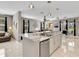 Bright kitchen island with granite countertops, pendant lighting and stainless steel dishwasher at 4180 Lenox Blvd, Venice, FL 34293