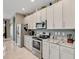 Modern kitchen with granite countertops, stainless steel appliances, and sleek white cabinets at 4180 Lenox Blvd, Venice, FL 34293
