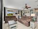 Open concept living room with tile floors, modern furnishings, and lots of natural light at 4180 Lenox Blvd, Venice, FL 34293