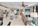 Spacious living room with open access to kitchen with bar seating and stainless appliances at 4180 Lenox Blvd, Venice, FL 34293