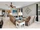 Open living room with tile floors, ceiling fan, and comfortable seating area at 4180 Lenox Blvd, Venice, FL 34293