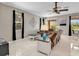 Inviting living room features tiled floors, comfortable seating, and a ceiling fan at 4180 Lenox Blvd, Venice, FL 34293