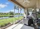 Screened patio offering a seating area and serene view of the pond and lush greenery at 4180 Lenox Blvd, Venice, FL 34293
