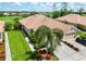 Lovely single-story home featuring a tile roof, lush landscaping, two-car garage, and a beautiful paver driveway at 4567 Whispering Oaks Dr, North Port, FL 34287
