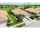 Aerial shot of a house with a well-maintained yard and proximity to the golf course at 4567 Whispering Oaks Dr, North Port, FL 34287