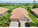 Beautiful home with lush landscaping, paver driveway, tile roof, and a two car garage from above at 4567 Whispering Oaks Dr, North Port, FL 34287