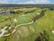Panoramic aerial view of the golf course surrounded by houses and lakes at 4567 Whispering Oaks Dr, North Port, FL 34287