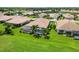 An aerial view of a beautiful backyard with a screened-in pool and lush green lawn at 4567 Whispering Oaks Dr, North Port, FL 34287