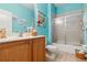 Well-lit bathroom boasts a new vanity, neutral tile flooring, and a shower-tub combo at 4567 Whispering Oaks Dr, North Port, FL 34287