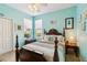 Charming bedroom with a blue-painted walls, four-poster bed, and two bright windows at 4567 Whispering Oaks Dr, North Port, FL 34287