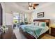 Main bedroom boasts tray ceiling, sliding doors, ceiling fan and stylish décor at 4567 Whispering Oaks Dr, North Port, FL 34287