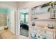 A charming peek into this bedroom's ensuite bath, features an inviting coastal cabinet decor at 4567 Whispering Oaks Dr, North Port, FL 34287