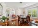Bright dining room features wood floors, decorative arches, and plantation shutters at 4567 Whispering Oaks Dr, North Port, FL 34287
